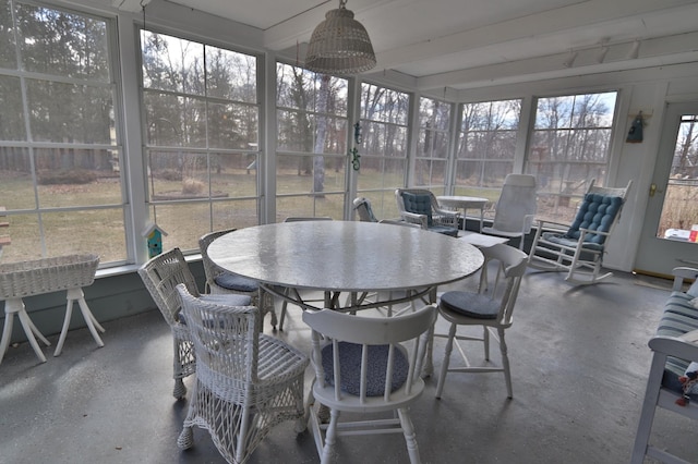 1138 Wintergreen Ln NE, Bemidji, MN 56601 - sunroom with outdoor dining space and beamed ceiling