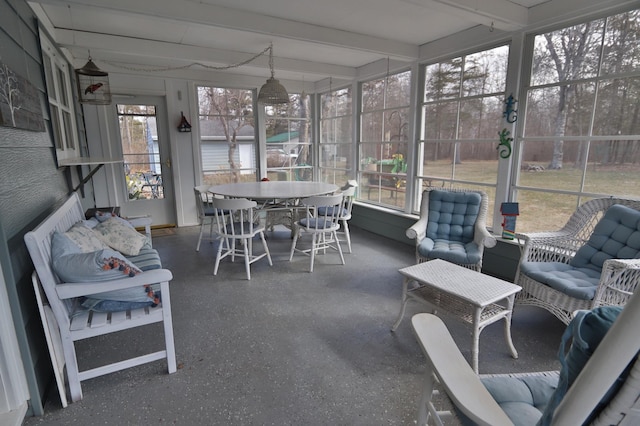 1138 Wintergreen Ln NE, Bemidji, MN 56601 - sunroom / solarium with plenty of natural light, outdoor dining area, and beam ceiling