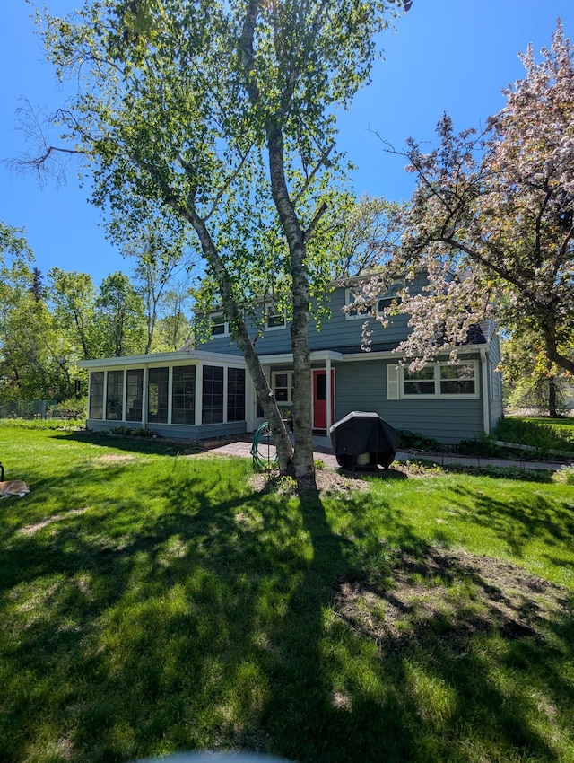1138 Wintergreen Ln NE, Bemidji, MN 56601 - back of property featuring a sunroom and a yard