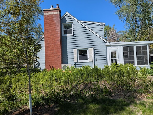 1138 Wintergreen Ln NE, Bemidji, MN 56601 - view of property exterior with a chimney and a sunroom