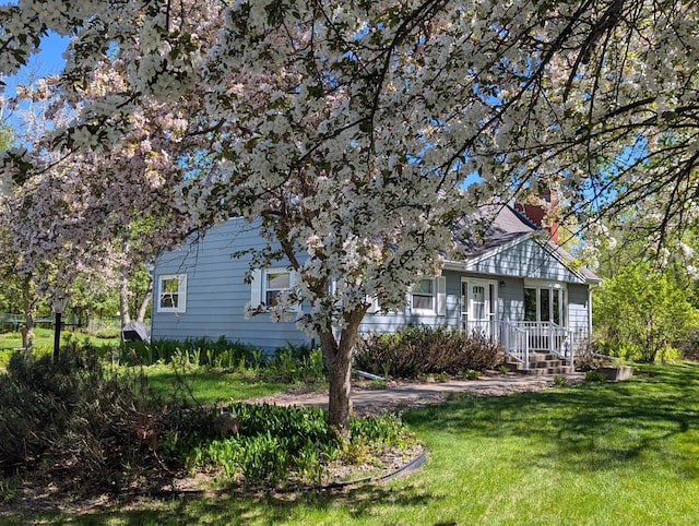 1138 Wintergreen Ln NE, Bemidji, MN 56601 - back of house featuring a yard and a chimney