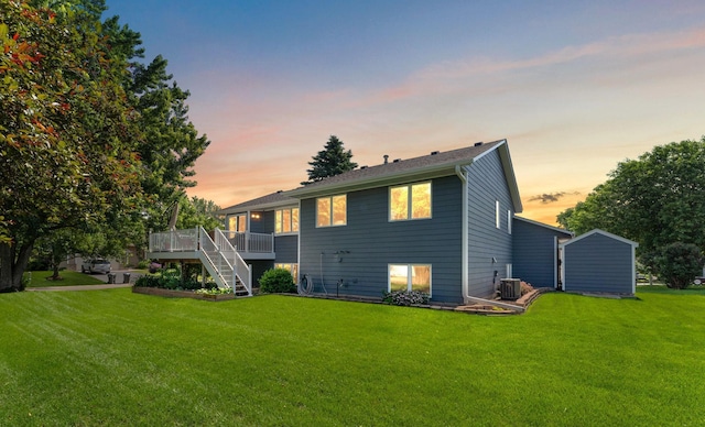 17317 Faraday Ct, Lakeville, MN 55024 - back of property at dusk featuring a deck, a yard, and stairs