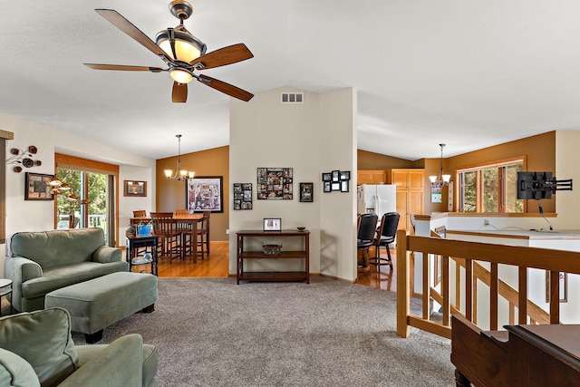 17317 Faraday Ct, Lakeville, MN 55024 - living area with a chandelier, vaulted ceiling, ceiling fan, and light carpet