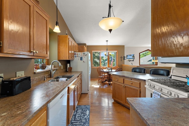 17317 Faraday Ct, Lakeville, MN 55024 - kitchen featuring white appliances, light wood finished floors, hanging light fixtures, extractor fan, and brown cabinets