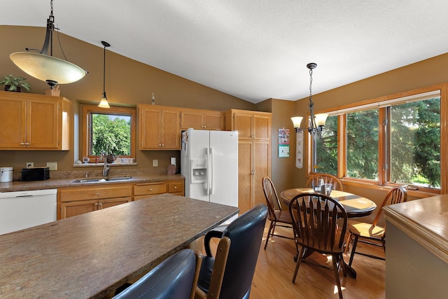 17317 Faraday Ct, Lakeville, MN 55024 - kitchen with white appliances, light wood-type flooring, lofted ceiling, a chandelier, and hanging light fixtures