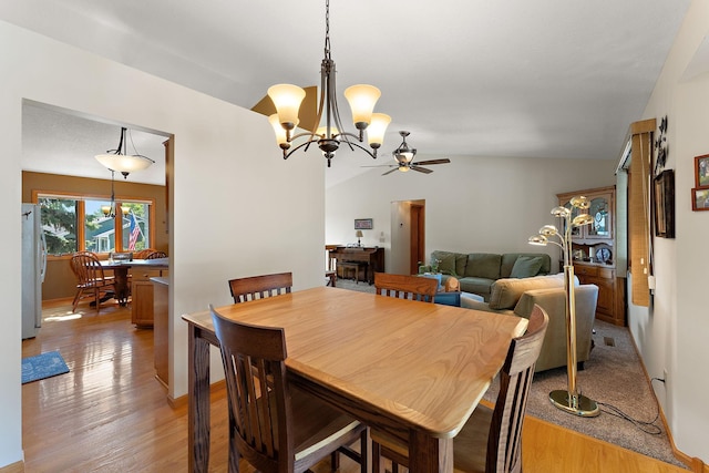 17317 Faraday Ct, Lakeville, MN 55024 - dining room with a chandelier, ceiling fan, vaulted ceiling, and light wood-type flooring