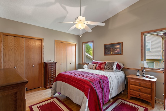 17317 Faraday Ct, Lakeville, MN 55024 - bedroom featuring light wood-type flooring, multiple closets, and a ceiling fan