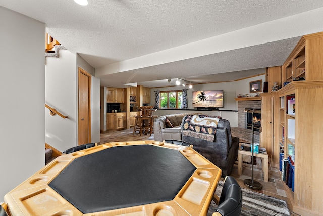17317 Faraday Ct, Lakeville, MN 55024 - game room featuring a fireplace and a textured ceiling