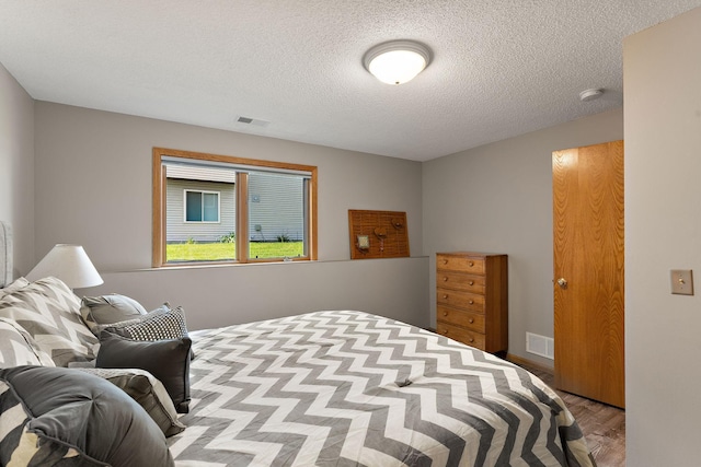 17317 Faraday Ct, Lakeville, MN 55024 - bedroom featuring a textured ceiling and wood finished floors