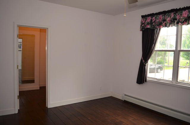 30155 Lakeview Ave, Wacouta Twp, MN 55066 - empty room with a baseboard heating unit, a ceiling fan, and dark wood-type flooring
