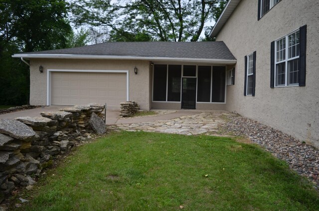 30155 Lakeview Ave, Wacouta Twp, MN 55066 - rear view of house featuring stucco siding, a garage, a lawn, and concrete driveway