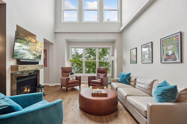 1020 Portland Ave, Minneapolis, MN 55404 - living area with a towering ceiling, a fireplace, healthy amount of natural light, and wood finished floors