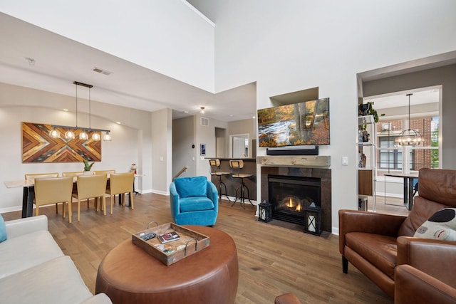 1020 Portland Ave, Minneapolis, MN 55404 - living room featuring a chandelier, wood finished floors, and a tile fireplace