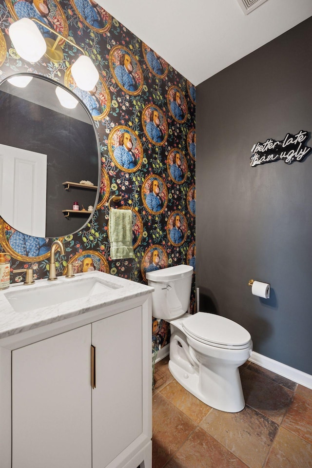 1020 Portland Ave, Minneapolis, MN 55404 - bathroom with vanity, stone tile flooring, and wallpapered walls