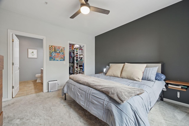 1020 Portland Ave, Minneapolis, MN 55404 - bedroom featuring a walk in closet, carpet floors, a closet, a ceiling fan, and ensuite bath