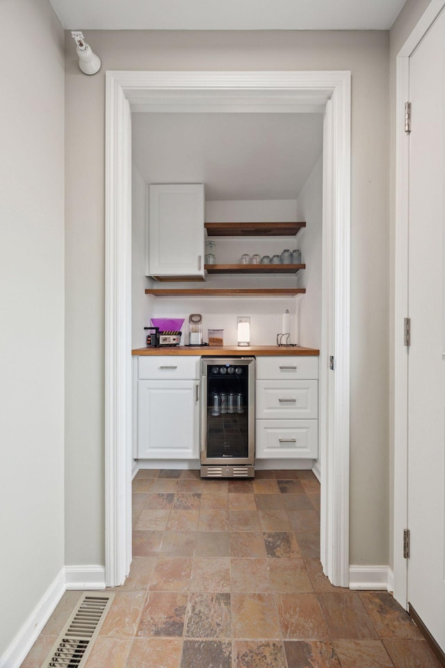 1020 Portland Ave, Minneapolis, MN 55404 - indoor dry bar featuring wine cooler and stone tile floors