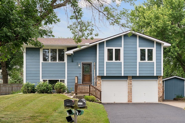1650 107th Ave NW, Coon Rapids, MN 55433 - raised ranch with asphalt driveway and a garage
