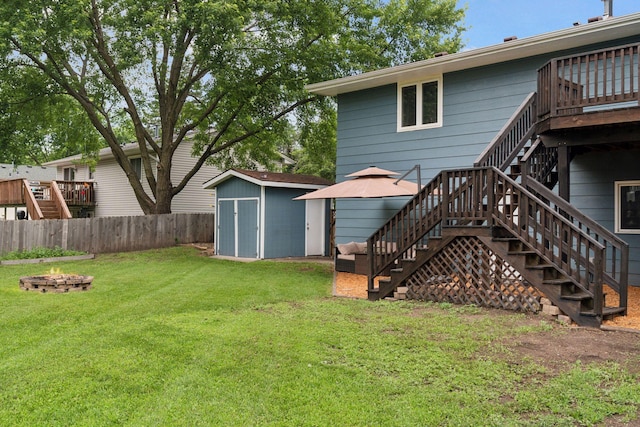 1650 107th Ave NW, Coon Rapids, MN 55433 - back of house with stairs, an outdoor fire pit, a storage shed, a fenced backyard, and a deck