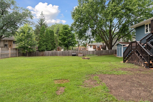 1650 107th Ave NW, Coon Rapids, MN 55433 - fenced backyard with a storage shed, stairway, and a fire pit