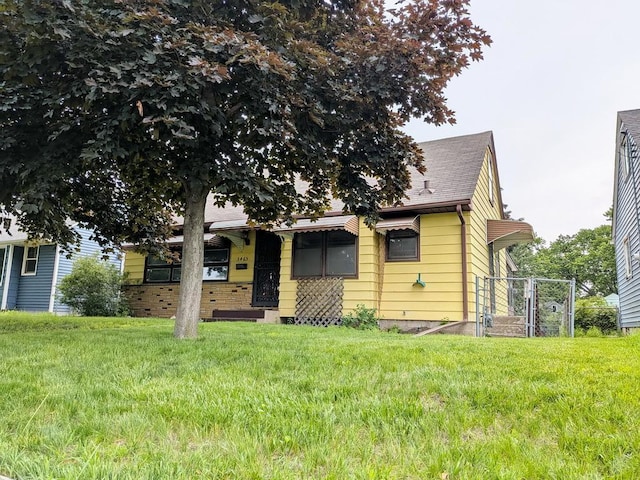 3465 5th St NE, Minneapolis, MN 55418 - view of front of property featuring a front yard and a shingled roof