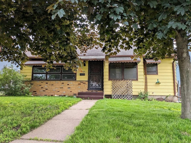 3465 5th St NE, Minneapolis, MN 55418 - view of front of home featuring a front lawn and roof with shingles