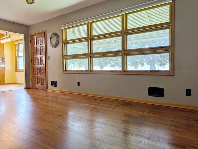 3465 5th St NE, Minneapolis, MN 55418 - foyer featuring wood finished floors, plenty of natural light, and a chandelier