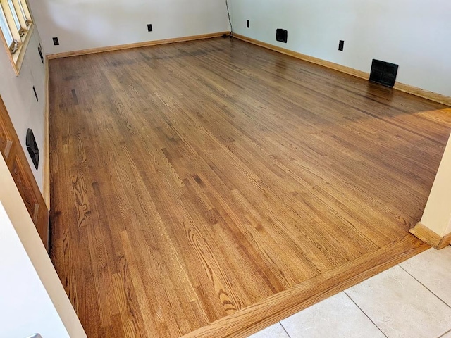 3465 5th St NE, Minneapolis, MN 55418 - unfurnished room featuring wood finished floors and baseboards