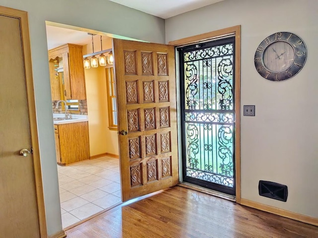 3465 5th St NE, Minneapolis, MN 55418 - foyer entrance with light wood-style flooring and baseboards