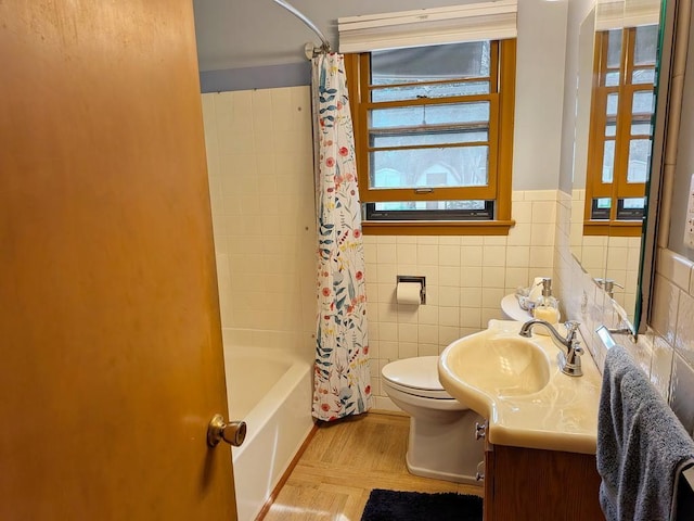 3465 5th St NE, Minneapolis, MN 55418 - bathroom featuring vanity, tile walls, shower / bath combo, and a wainscoted wall