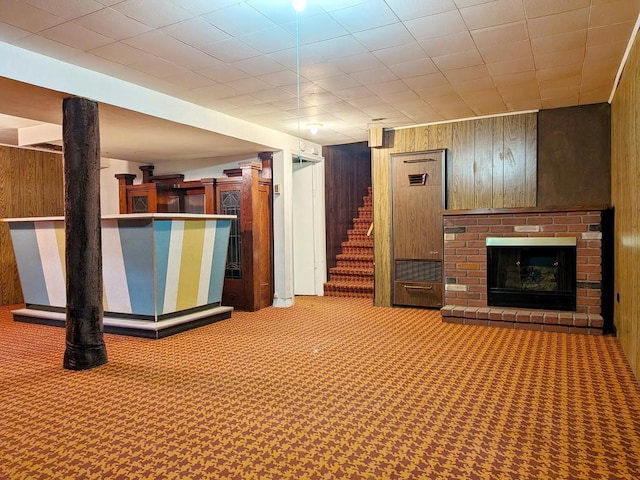 3465 5th St NE, Minneapolis, MN 55418 - finished below grade area featuring wood walls, carpet flooring, stairs, a brick fireplace, and a bar