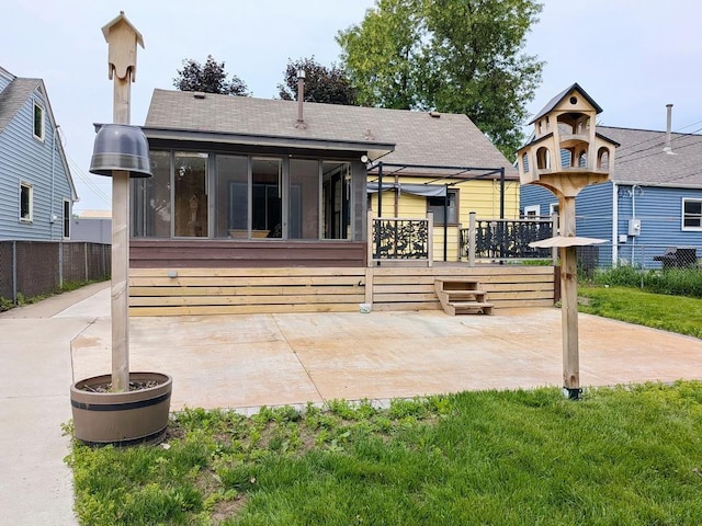 3465 5th St NE, Minneapolis, MN 55418 - back of house with a sunroom, a wooden deck, a patio area, and roof with shingles