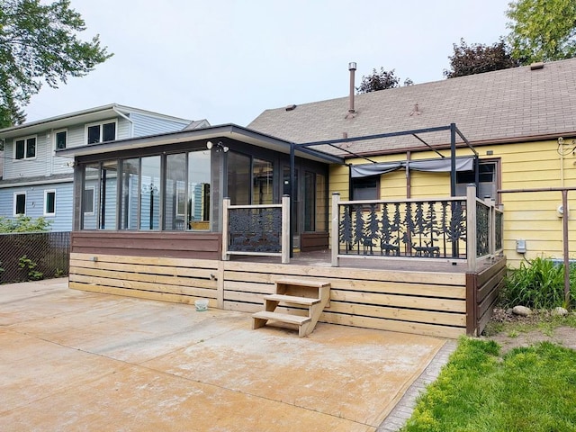 3465 5th St NE, Minneapolis, MN 55418 - back of house featuring a sunroom, a patio, and roof with shingles