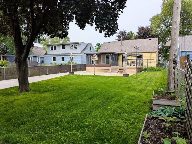 3465 5th St NE, Minneapolis, MN 55418 - rear view of house with a vegetable garden and a wooden deck
