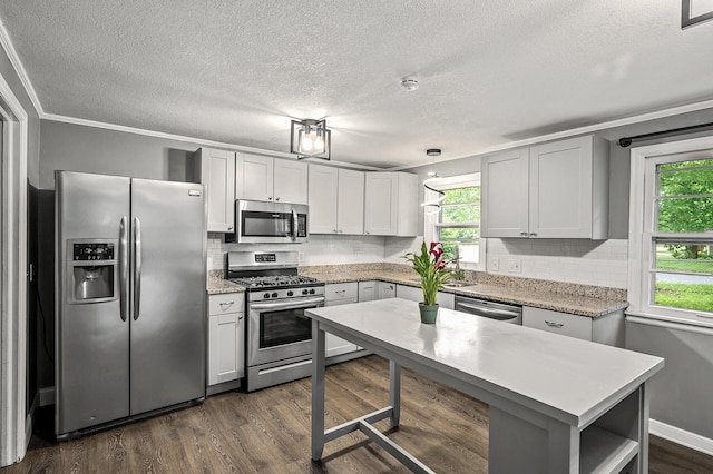 6289 Edgewood Ave N, Brooklyn Park, MN 55428 - kitchen with appliances with stainless steel finishes, a textured ceiling, healthy amount of natural light, tasteful backsplash, and ornamental molding