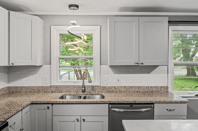 6289 Edgewood Ave N, Brooklyn Park, MN 55428 - kitchen with stainless steel dishwasher, decorative backsplash, light stone countertops, crown molding, and hanging light fixtures