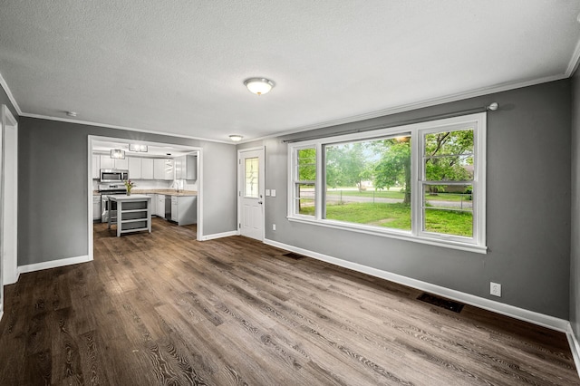 6289 Edgewood Ave N, Brooklyn Park, MN 55428 - unfurnished living room featuring ornamental molding, dark wood finished floors, and a textured ceiling