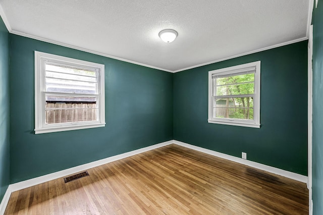 6289 Edgewood Ave N, Brooklyn Park, MN 55428 - empty room with crown molding, a textured ceiling, and wood finished floors