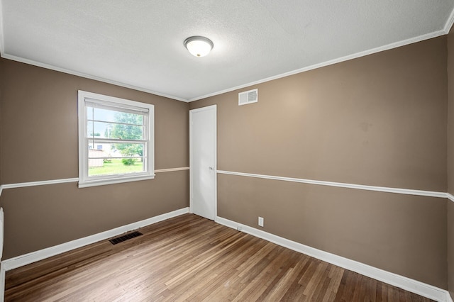 6289 Edgewood Ave N, Brooklyn Park, MN 55428 - unfurnished room featuring wood finished floors, ornamental molding, and a textured ceiling