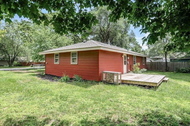 6289 Edgewood Ave N, Brooklyn Park, MN 55428 - back of house featuring a fenced backyard, a wooden deck, and roof with shingles