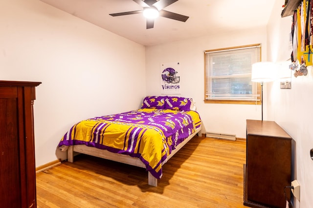 2303 9th Ave SW, Austin, MN 55912 - bedroom with light wood finished floors, a baseboard radiator, and ceiling fan