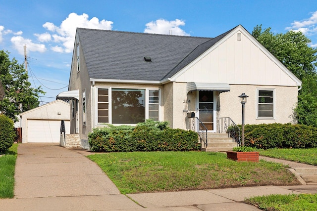2514 5th St NE, Minneapolis, MN 55418 - view of front of house with driveway, a front lawn, and roof with shingles