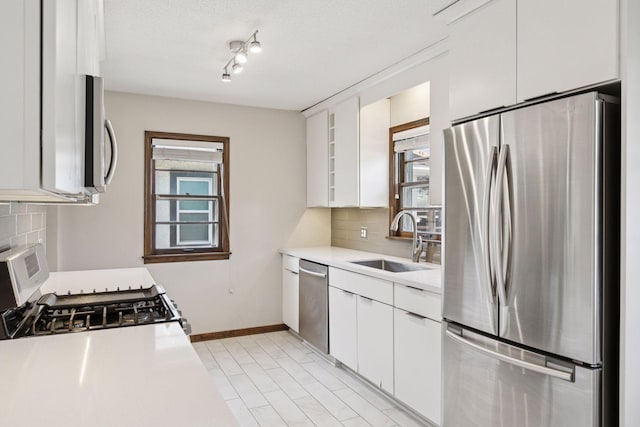 2514 5th St NE, Minneapolis, MN 55418 - kitchen with stainless steel appliances, healthy amount of natural light, decorative backsplash, and a textured ceiling