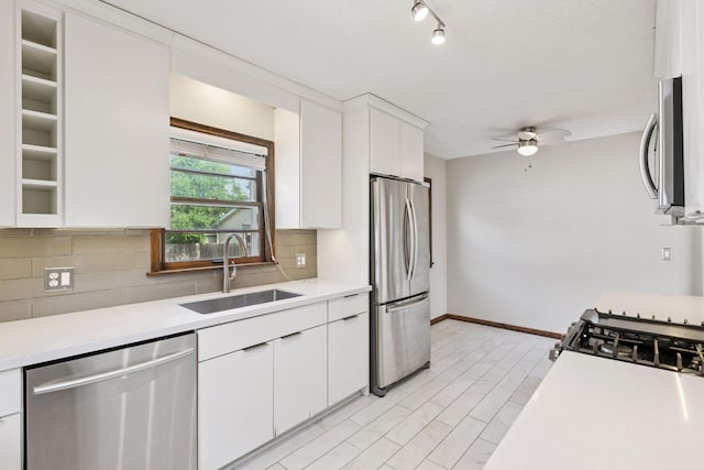 2514 5th St NE, Minneapolis, MN 55418 - kitchen featuring stainless steel appliances, light countertops, tasteful backsplash, a ceiling fan, and white cabinetry