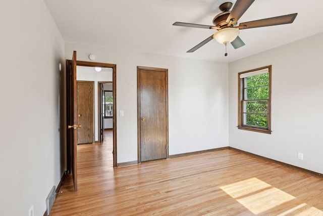2514 5th St NE, Minneapolis, MN 55418 - unfurnished bedroom with light wood finished floors and a ceiling fan
