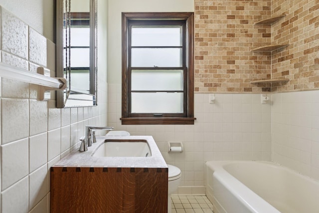 2514 5th St NE, Minneapolis, MN 55418 - full bathroom featuring tile walls, a tub, vanity, tile patterned floors, and a wainscoted wall