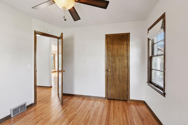 2514 5th St NE, Minneapolis, MN 55418 - unfurnished bedroom with light wood-style floors and a ceiling fan