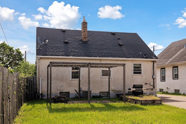 2514 5th St NE, Minneapolis, MN 55418 - rear view of property with stucco siding, a chimney, and a shingled roof