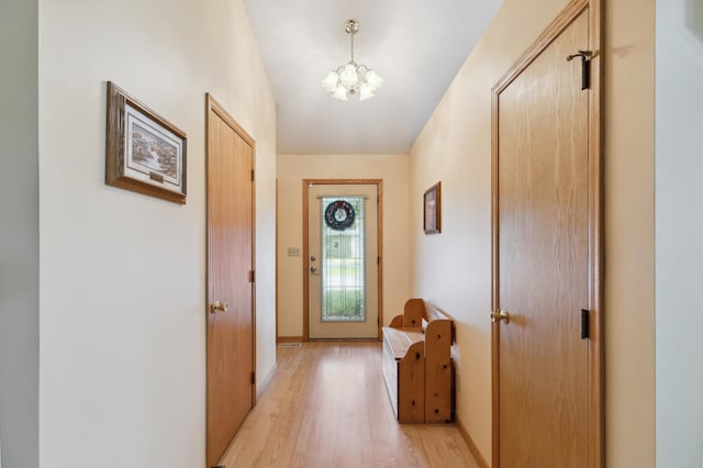 3147 94th Ln NE, Blaine, MN 55449 - entryway with light wood finished floors and a chandelier