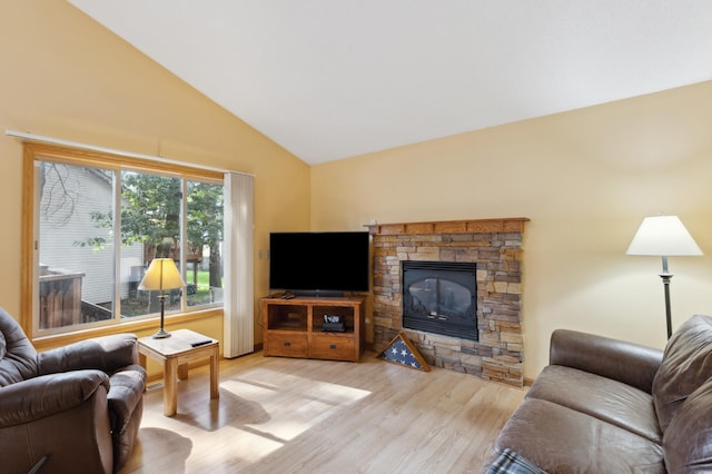 3147 94th Ln NE, Blaine, MN 55449 - living area featuring vaulted ceiling, wood finished floors, and a stone fireplace