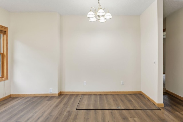 2070 Racine Ave S, Lake Saint Croix Beach, MN 55043 - empty room featuring wood finished floors and a chandelier